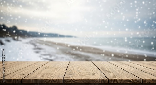 Wooden table top with blur winter sea and snow falling background scene