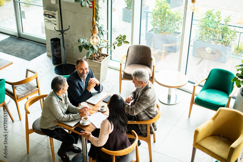 Business colleagues having a meeting in a cafe