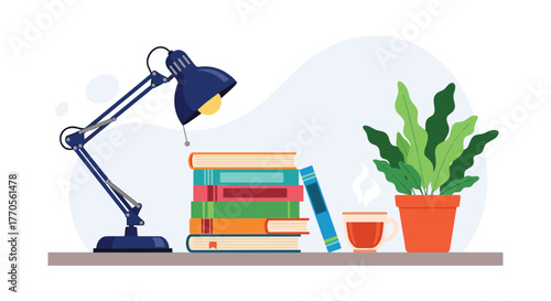 Desk setup with a lamp, stack of books, a potted plant, and a cup of tea.