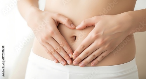 Wallpaper Mural Close-up view of a heart shaped hand touching stomach, representing gut health, abdominal comfort, digestion, and nutrition care in a clean minimal wellness concept. Torontodigital.ca