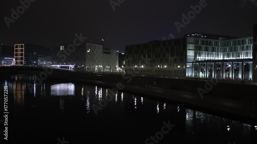 Evening glow, Berlin skyline, Urban Berlin. River in Berlin captures radiant facades modern buildings at night.