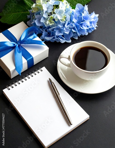 Morning Inspiration - Coffee, Gift, and Notebook on Dark Surface.