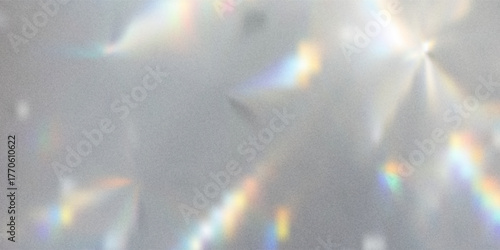 Blurred rainbow light refraction texture overlay effect for photo and mockups. Organic drop diagonal holographic flare on a white wall. Shadows for natural light effects