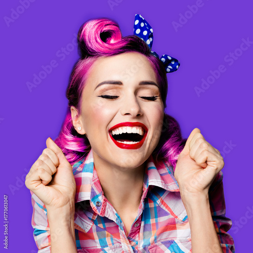 WOW! Unbelievable news! Excited surprised very happy red hair woman. Astonished pinup girl with open mouth and close eyes, raises hands fists. Retro and vintage concept. Violet purple background