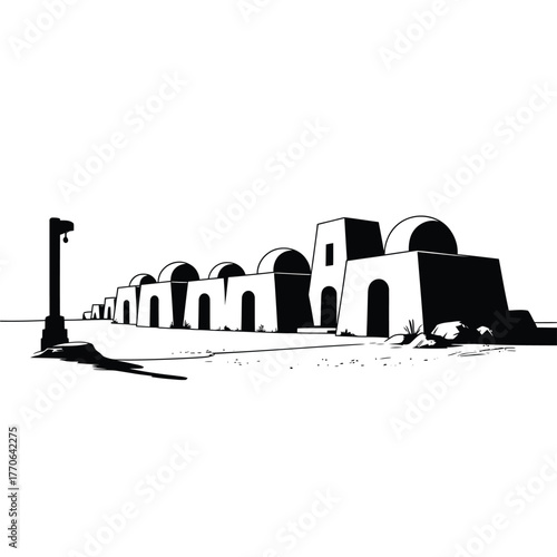 Desert village with arched buildings and a single street lamp