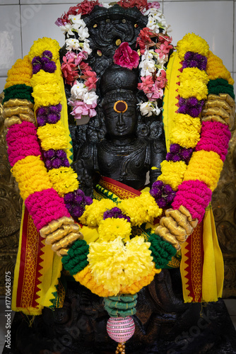 Statue of the Hindu deity Shiva with floral offering