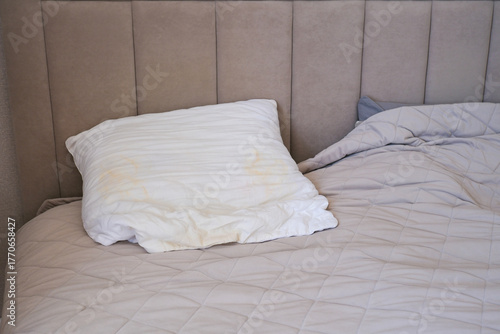 A white pillow with yellow spots.