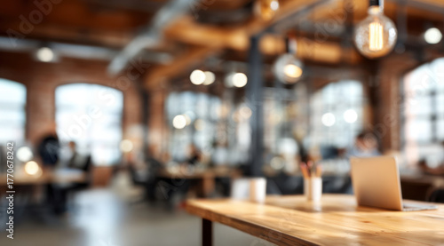 Wallpaper Mural Modern office interior with a wooden desk, laptop and pen holder in a bright, open-plan coworking space. Ideal background for business, startup, remote work and collaboration photos Torontodigital.ca