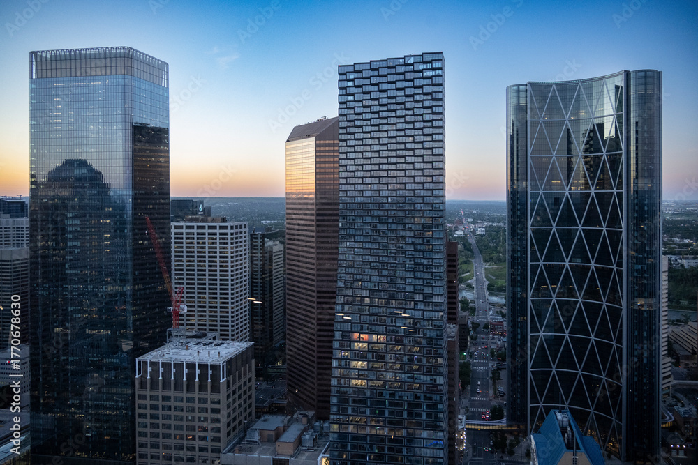 Urban skyline at sunset featuring modern skyscrapers and cityscape view. Calgary, Alberta, Canada