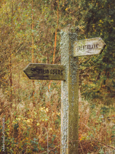 A lichen covered fingerpost sign in the Peak District pointing to Shutlingsloe and Trentabank