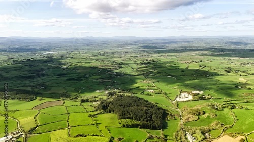 Serene countryside panorama. Picturesque farmland, vibrant green fields, and charming rural scenes. A tranquil visual for any project.