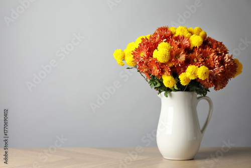 Wallpaper Mural Autumn atmosphere. Vase with beautiful flowers on wooden table, space for text Torontodigital.ca