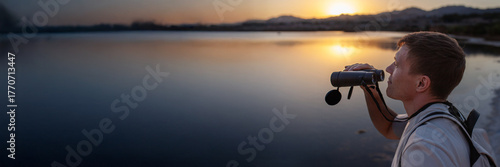 Man watching birds through binoculars, immersive point of view, Eilat Israel