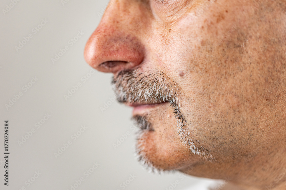 Fototapeta premium Mature male with beard and mustache lower face part in profile