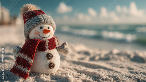 Cheerful sandy snowman with red scarf and hat enjoying sunny beach day by the ocean, christmas concept