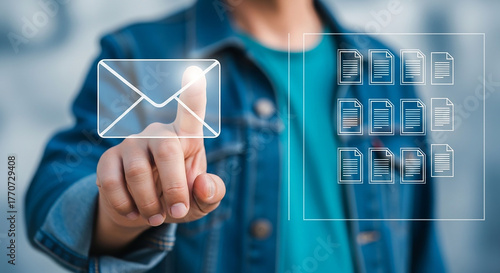 Businessman's hand presses a virtual email button on a touch screen interface, representing digital communication and future business technology