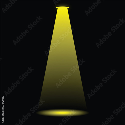 A single spotlight beam illuminates a dark and empty stage area