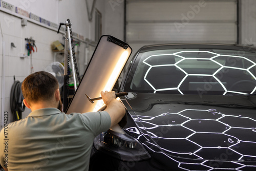 Mechanic Fixing Hail Dents with PDR Tools