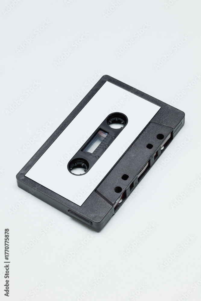Obraz premium Black plastic audio cassette tape with blank label. Vintage Retro acoustic.