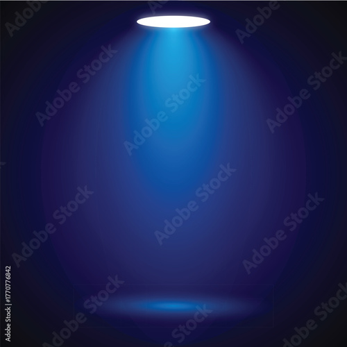 A single spotlight illuminates a dark blue empty stage background