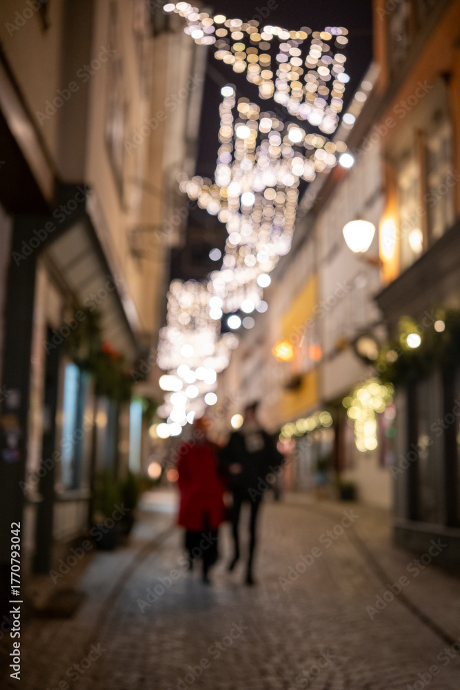 Fototapeta premium intimate couple exploring bustling festive boulevard with glowing lights and reflective wet pavement