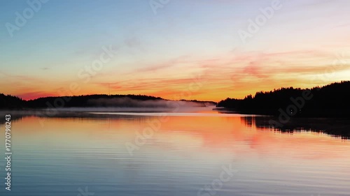 Wallpaper Mural Beautiful autumn sunrise over the sea with golden sunlight, soft fog drifting above the water and forest coastline, peaceful nature scenery in 4K ultra HD Torontodigital.ca