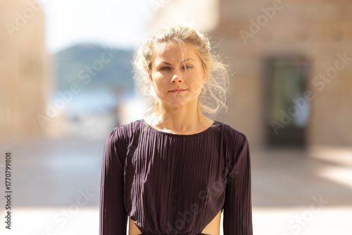 Young woman confidently looking at camera outdoors