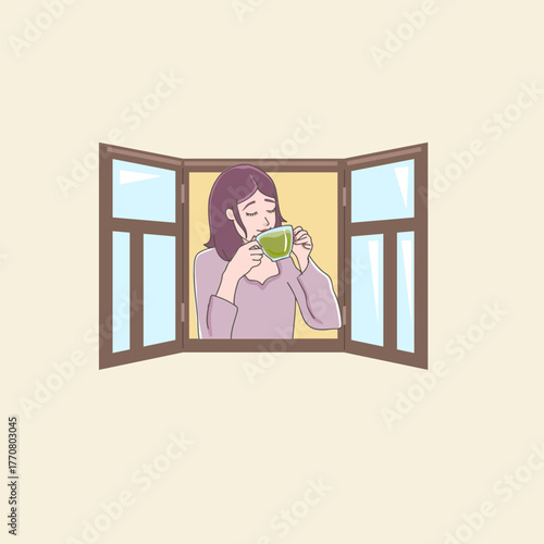 woman looking from the window and drinking matcha