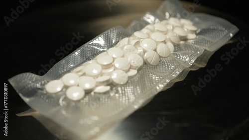 Powder drugs pressed in pills shape and packaged in to vacuum bags for transportation. Stash of Oxy, Meth, Fentanyl or synthetic opioid drugs, seized by police or security, illegal drugs trafficking.