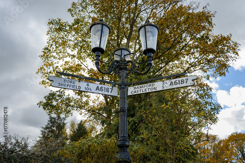 Old road sign in Hathersage village center Peak District Derbyshire UK
