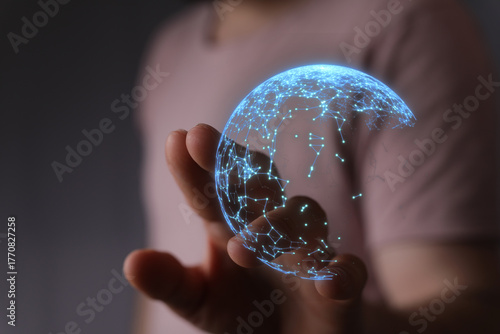 A person holds a glowing di...