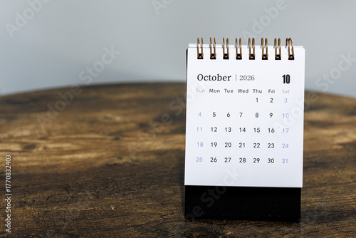 October 2026 calendar monthly page on wooden table background