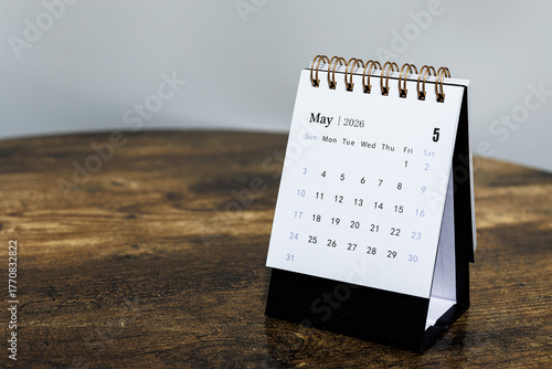 May 2026 monthly calendar page on a wooden desk, minimal design planner representing time management and organization at workplace