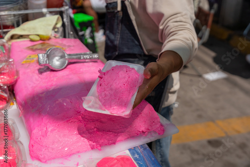 Canvas Print Turrón Candy, Close up of a man's hands slicing a block of bright pink artisanal nougat with a long knife