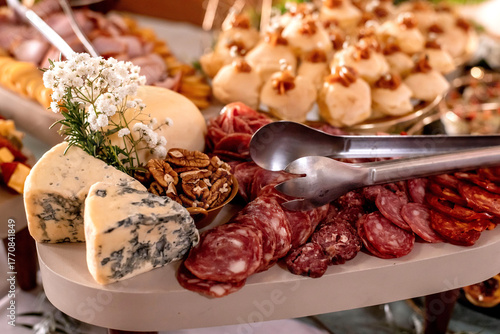 Cold snack platter with cheese, salami and nuts