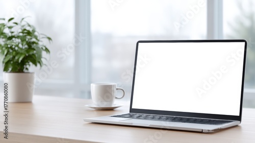 Wallpaper Mural Laptop mock up with blank screen on wooden desk beside coffee cup and potted plant, creating a serene workspace atmosphere with natural light Torontodigital.ca
