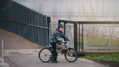 Boy Riding Bicycle Outdoors in Urban Park