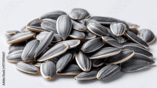 A pile of sunflower seeds, a healthy and tasty snack. The seeds are black and white, and arranged in a pile