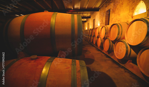 Photos Selective focus on wooden barrels for wine aging in the cellar