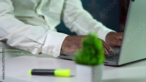 man working on laptop in office.