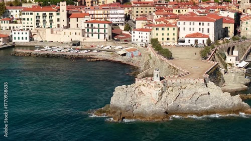 Italy , Tuscany tourism scenic places and coastal towns - charming Piombino in Livorno province. aerial drone 4k hd footage with lighthouse and old town