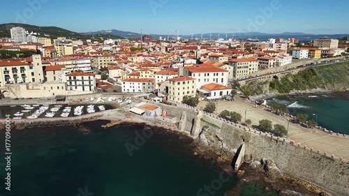 Italy , Tuscany tourism scenic places and coastal towns - charming Piombino in Livorno province. aerial drone 4k hd footage with lighthouse and old town