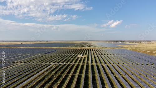 Dolly style Drone Clip of a massive solar farm in the southwest USA mostly sunny day