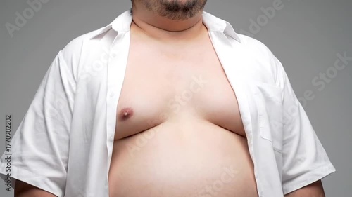 Close Up of Overweight Male Torso with Open White Shirt Against Neutral Background