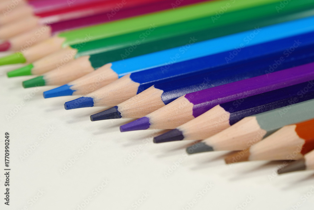 Fototapeta premium New wooden colored pencils of rainbow colors, perfectly sharpened, lie on table
