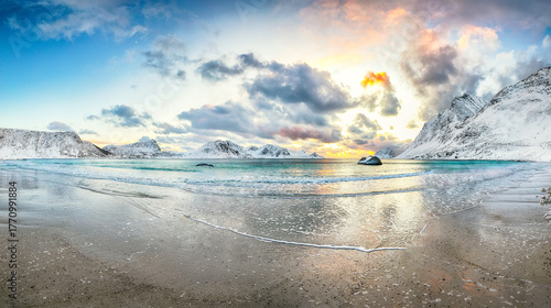 Stunning winter scenery with Haukland beach during sunset and snowy  mountain peaks near Leknes.