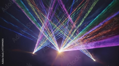 Colorful laser beams intersecting in dark space abstract digital background of light effects and motion