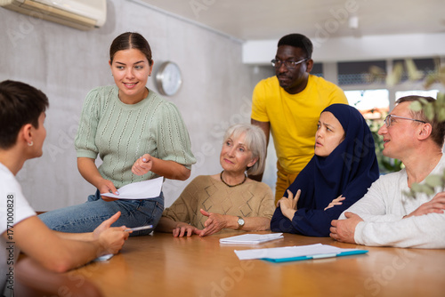 Group students different ages and multinational discussion during business course