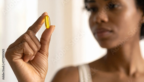 Hand Holding Fish Oil Capsule