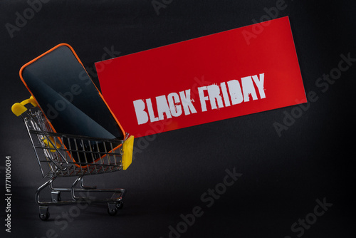 Smartphone in shopping cart with black friday sign representing online shopping deals